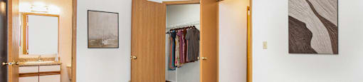 a bedroom with a bed and a closet and a bathroom