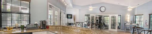 a large kitchen with granite countertops and stainless steel appliances