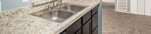 a kitchen with granite countertops and a sink