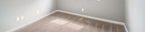 an empty bedroom with a large window