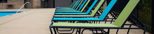 a row of pool chairs in front of a building