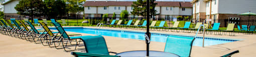 our apartments have a resort style pool with chairs and tables