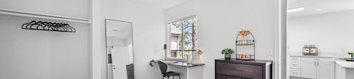 A bedroom with a bed, desk, and chair.