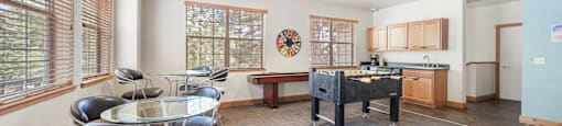 A conference room with a table, chairs, and a fan.