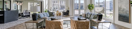A living room with a large window and a view of the city.