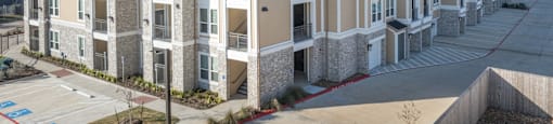 A row of modern apartment buildings with balconies and garages.