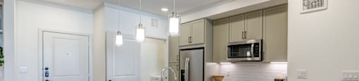 A kitchen with a granite countertop and bar stools.