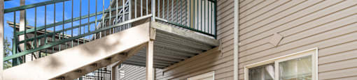 the front of a house with stairs and a white door
