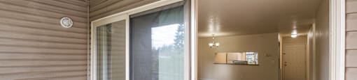 a sliding glass door is open to a room in a home