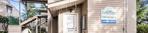 the front door of a house with a white door and a sign on the side