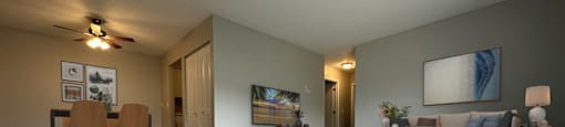 a living room with gray walls and a ceiling fan