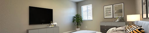 a master bedroom with a large bed and a tv