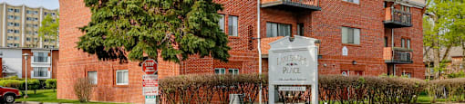 A red brick apartment building with a sign that says "Lakeside Place".