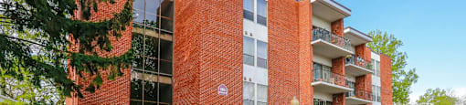 A red brick building with a black door and windows.
