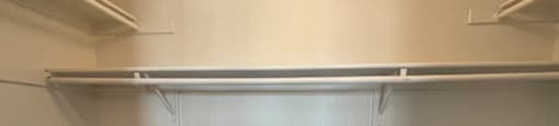 Empty white shelves in a room.