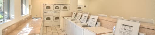 A laundromat with rows of washers and dryers.