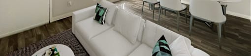 A living room with a white couch and a coffee table.