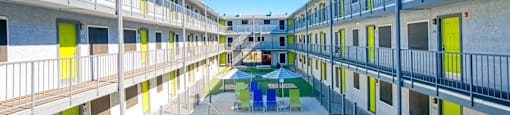 A pool is surrounded by apartment buildings.