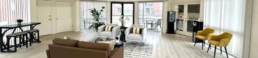 A spacious living room with a brown sofa and a yellow chair.