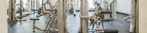A gym with a variety of equipment including a leg press machine.