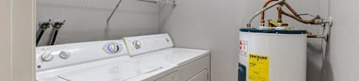 A small laundry room with a washer and dryer.
