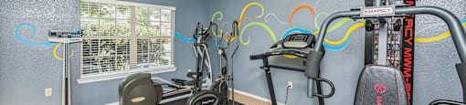 A gym with exercise equipment and a window.