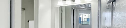 A white bathroom with a toilet, sink, and medicine cabinet.