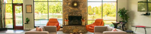 A living room with a fireplace and two couches.