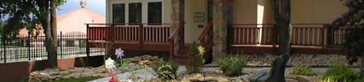 The exterior of the Cedar Ridge Apartments clubhouse with a welcoming entrance.