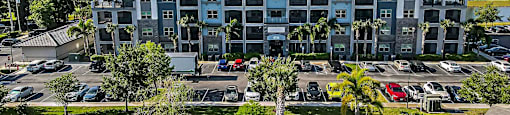 an aerial view of an apartment building in a parking lot
