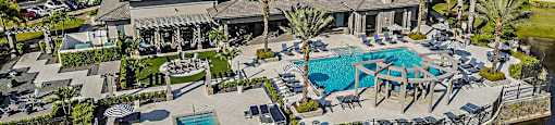 a mansion with a swimming pool and patio furniture