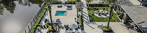 an aerial view of a swimming pool and patio with chairs