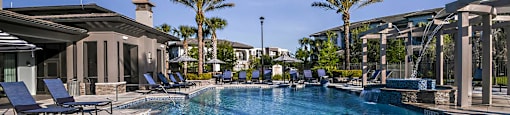 a swimming pool at a resort with palm trees