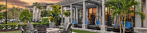 a patio with a table and chairs in front of a house