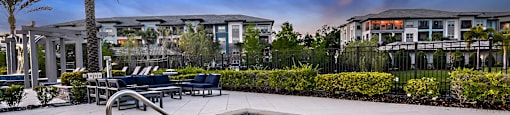 a hot tub on a patio with buildings in the background