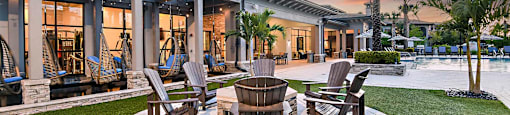 a patio with a table and chairs and a pool