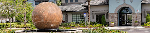 A large building with a large sculpture in front of it.