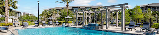 A large swimming pool with a bridge over it.