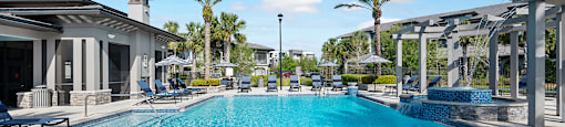 A long rectangular swimming pool with a blue tinted water.