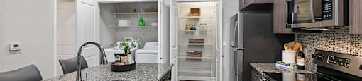 A kitchen with granite countertops and stainless steel appliances.