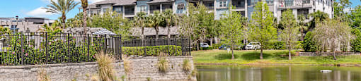 A large building with a pond in front of it.