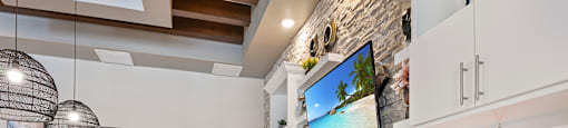 A modern kitchen with a white countertop and a coffee sign.