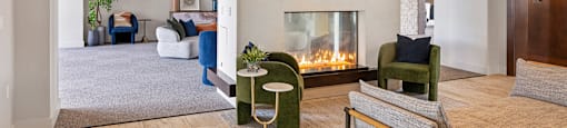 A living room with a fireplace and a painting on the wall.