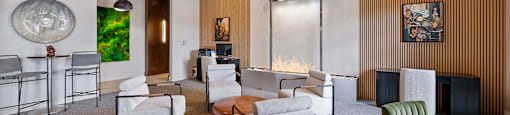 A modern living room with a grey carpet and wooden paneling on the wall.