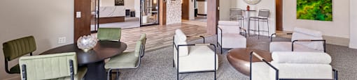 A modern living room with a dining table and chairs.