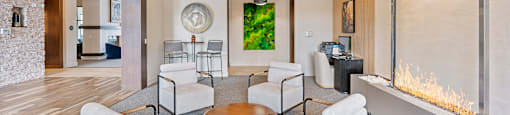 A modern living room with a fireplace and a painting on the wall.