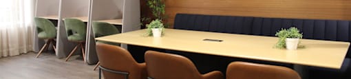 A conference room with a long table and chairs.