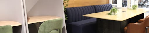 A room with a blue couch and a table with chairs.