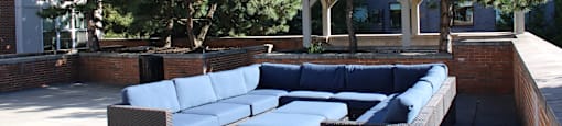 A patio with a couch and a table.
