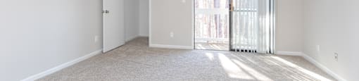 a bedroom with a sliding glass door leading to a balcony at Tiffany Square, Rocky Mount, NC